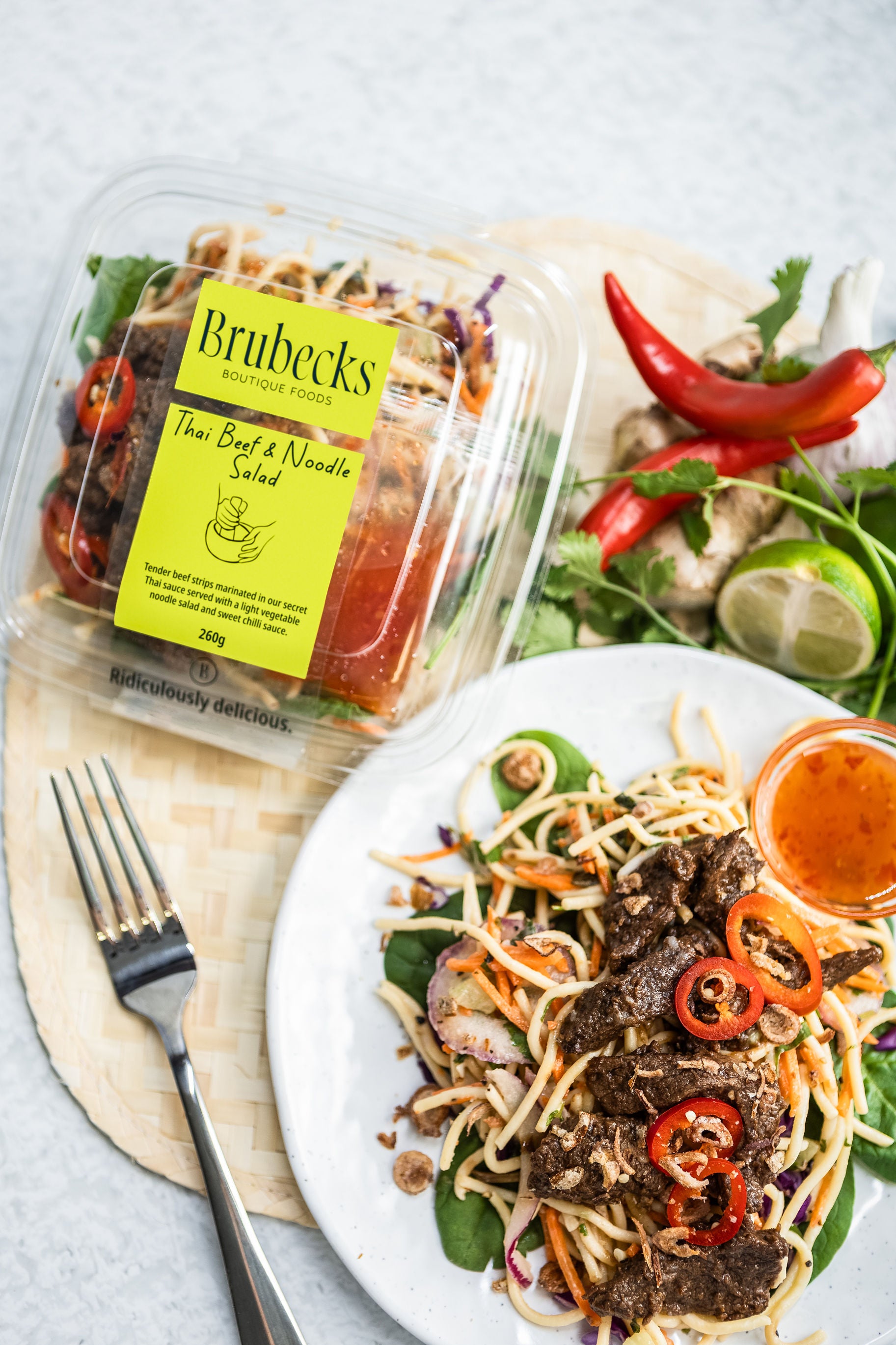 Brubeck's Thai Beef Noodle Salad packaging with a prepared salad on a plate.