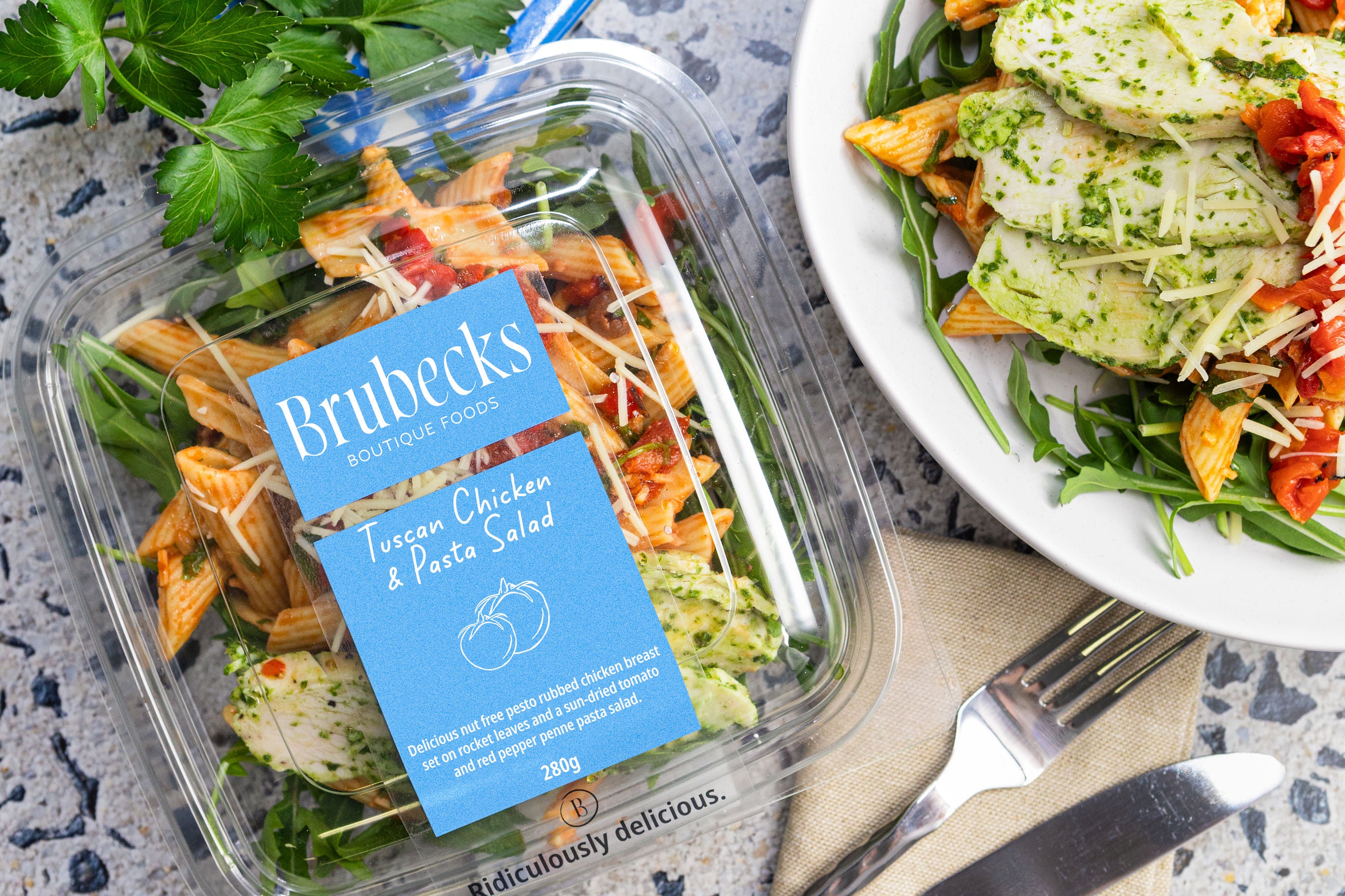 Brubecks Tuscan Chicken & Pasta Salad packaging with a served salad on a plate.