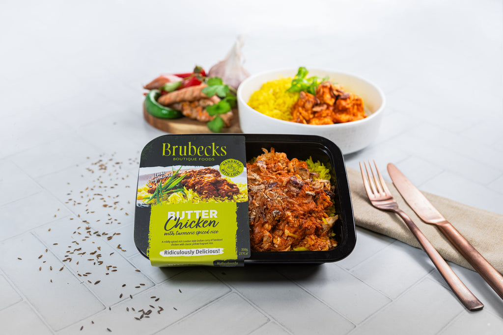 Brubecks Butter Chicken meal package on a table with a fork and knife.