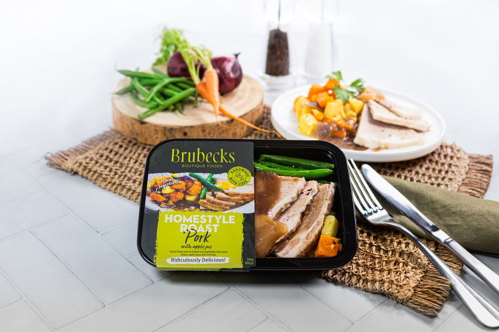 Brubecks homestyle roast pork package on a table with vegetables and cutlery