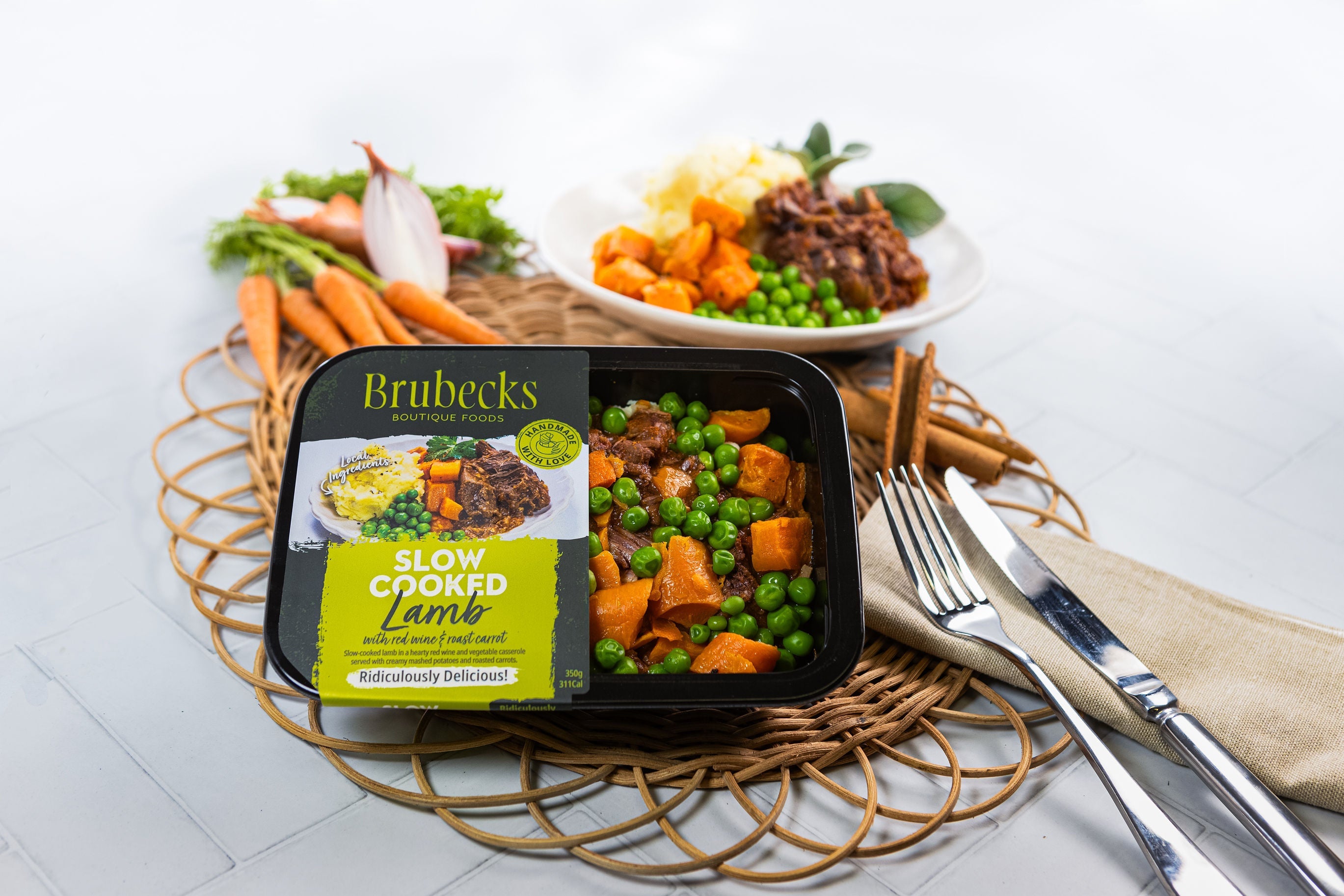 Brubecks slow cooked lamb meal kit on a table with a fork and knife.