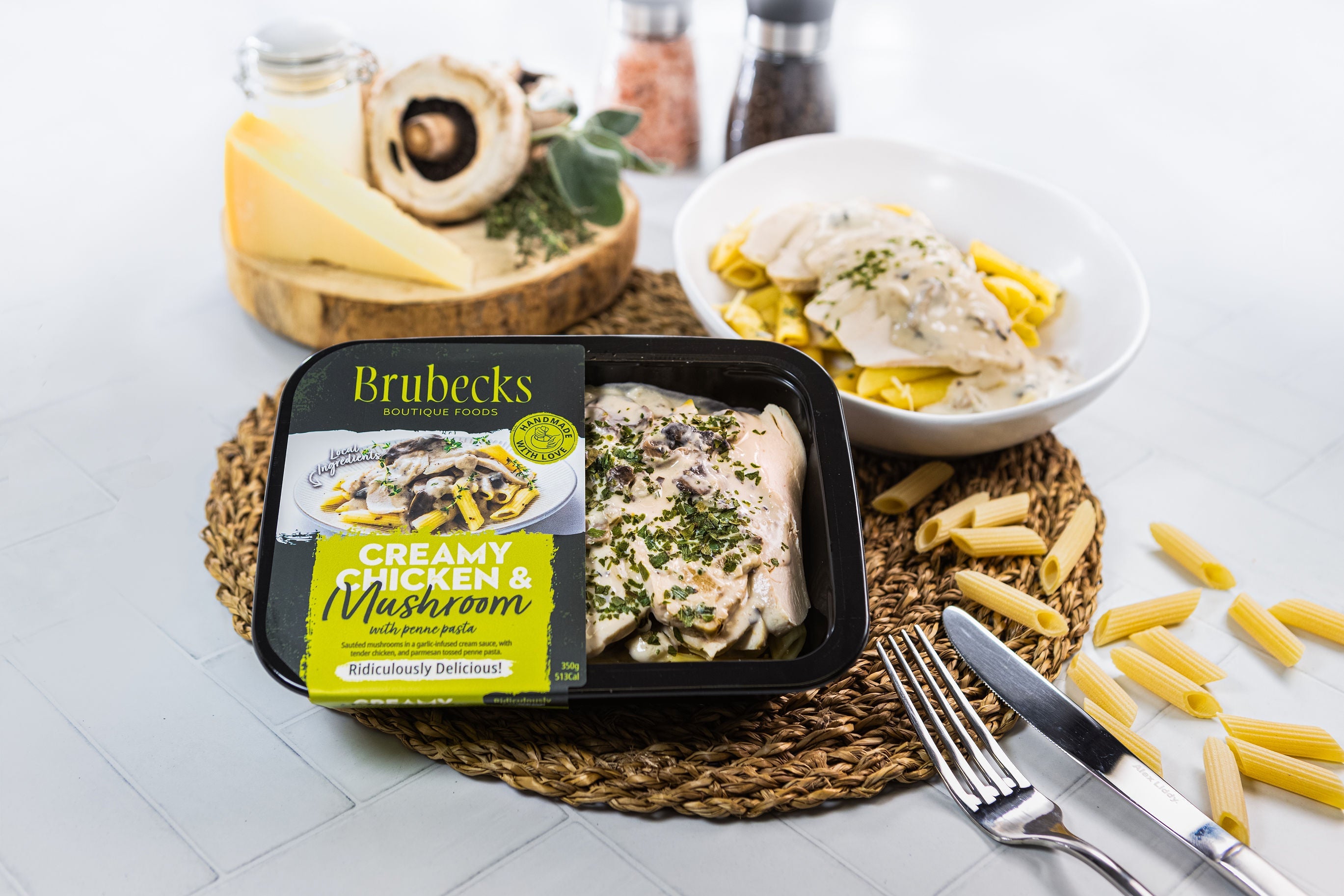 Brubecks creamy chicken and mushroom meal kit on a table with pasta and cheese.