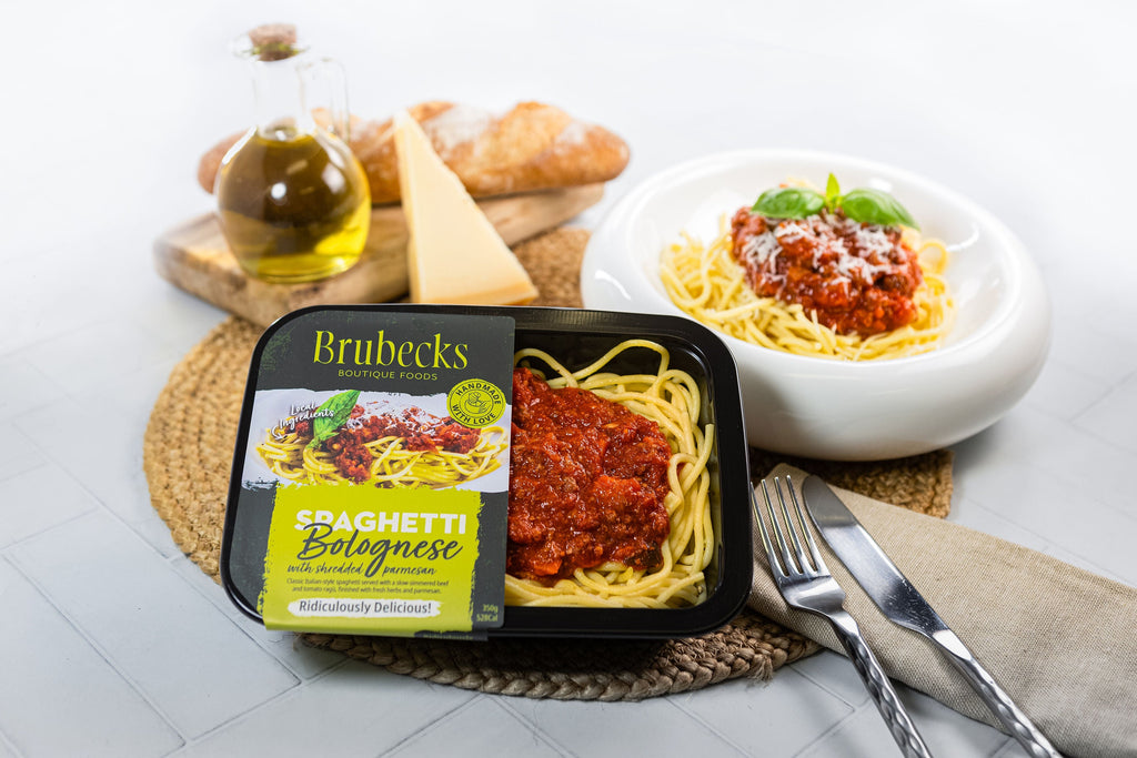 Brubeck's Spaghetti Bolognese package with a bowl of spaghetti and a loaf of bread on a white surface.