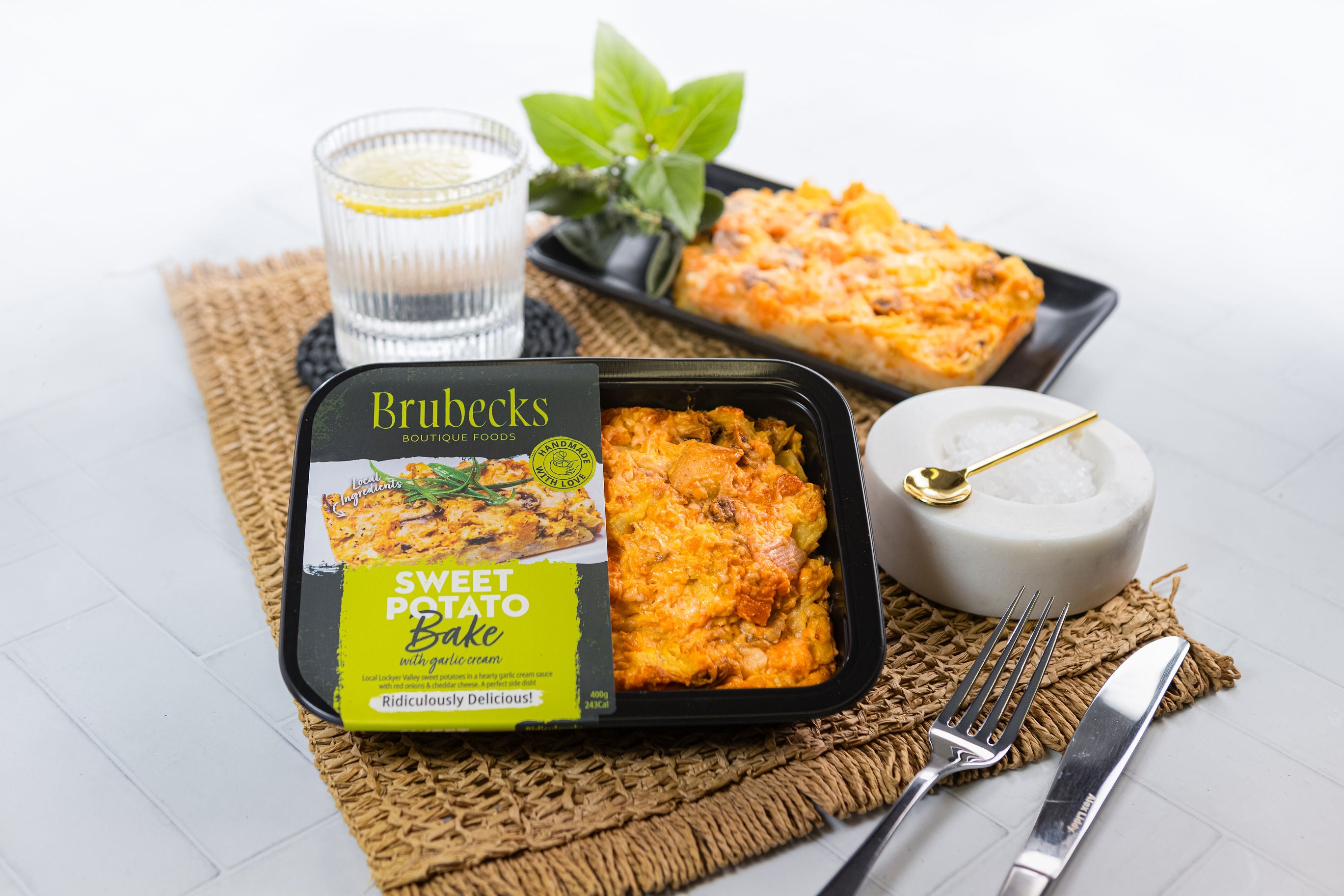 Brubecks Sweet Potato Bake package on a table with a glass of water and a candle.
