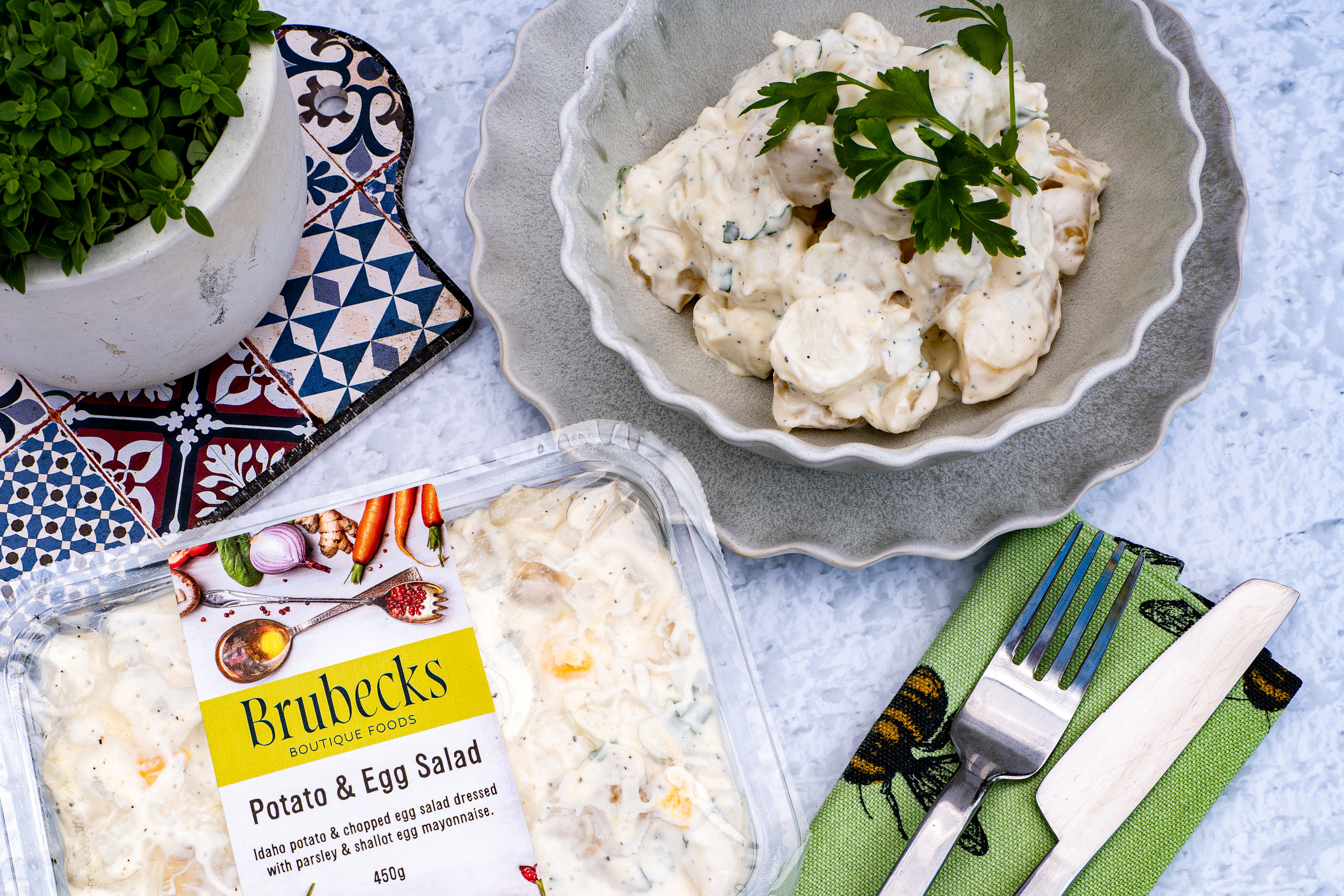 Brubecks Potato & Egg Salad packaging with a bowl of salad on a textured surface