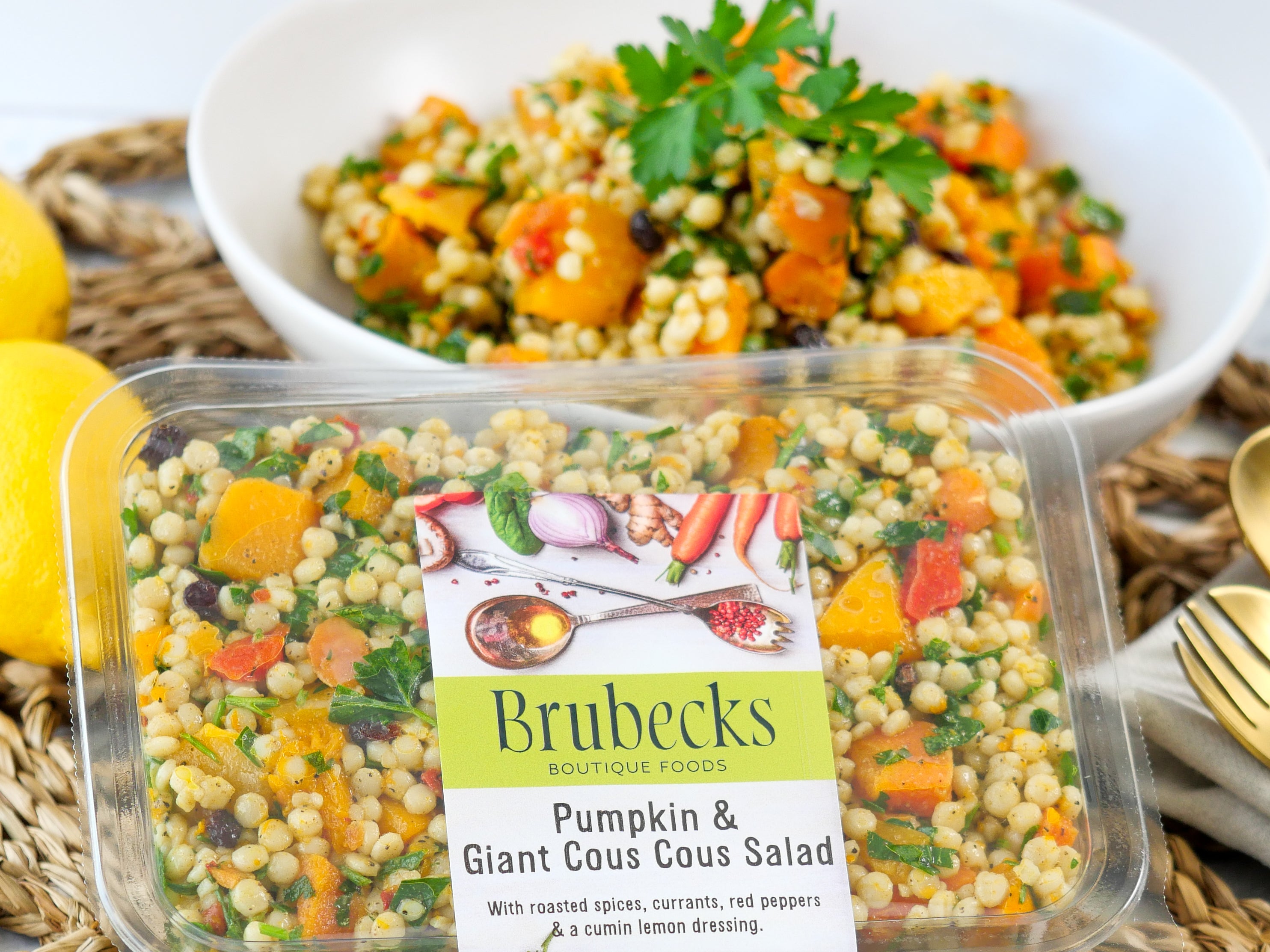 Brubecks Pumpkin & Giant Cous Cous Salad packaging with a bowl of salad in the background.