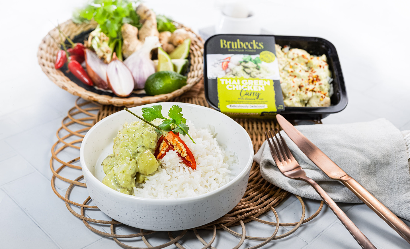 Bowl of rice with green sauce on a table with Brubecks product in the background