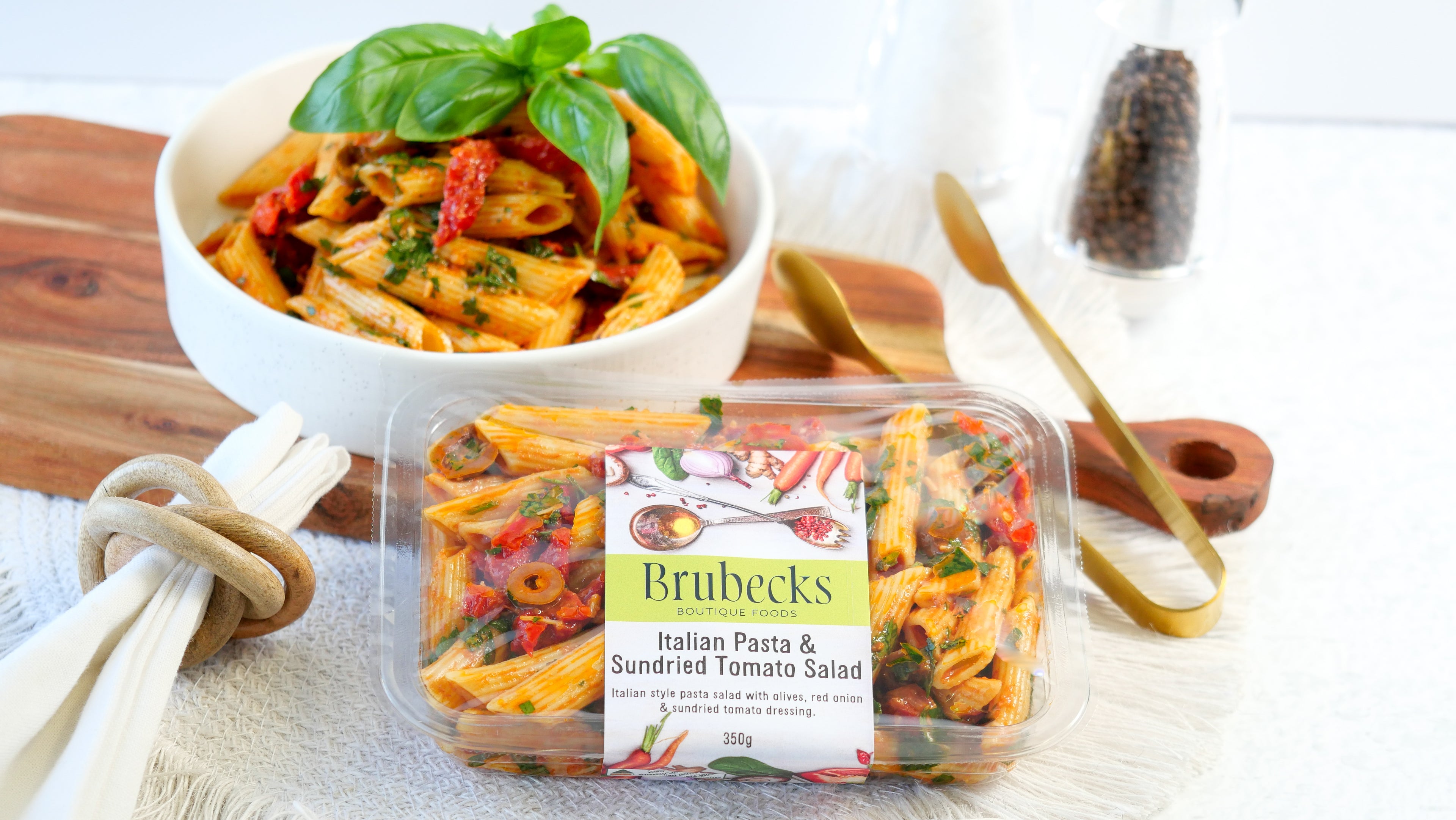 Brubecks Italian Pasta & Sundried Tomato Salad packaging with a bowl of salad in the background.