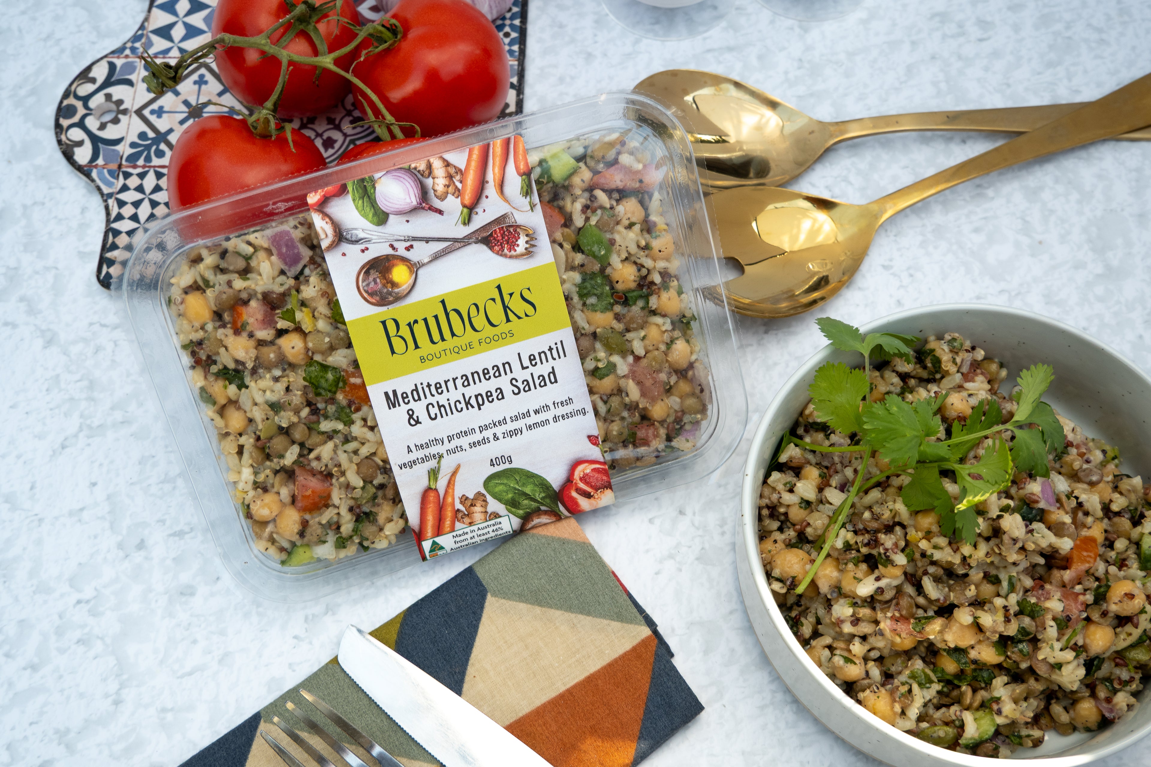 Brubeck's Mediterranean Lentil & Chickpea Salad packaging with a bowl of salad on a textured surface.