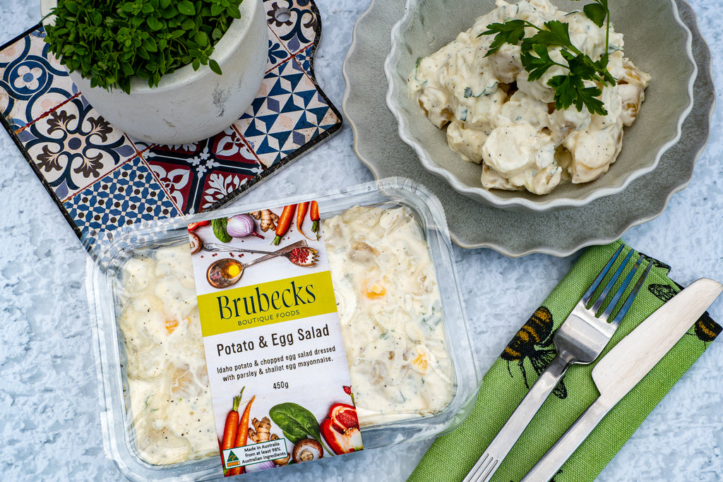 Brubecks Potato & Egg Salad packaging with a bowl of salad on a decorative tablecloth.