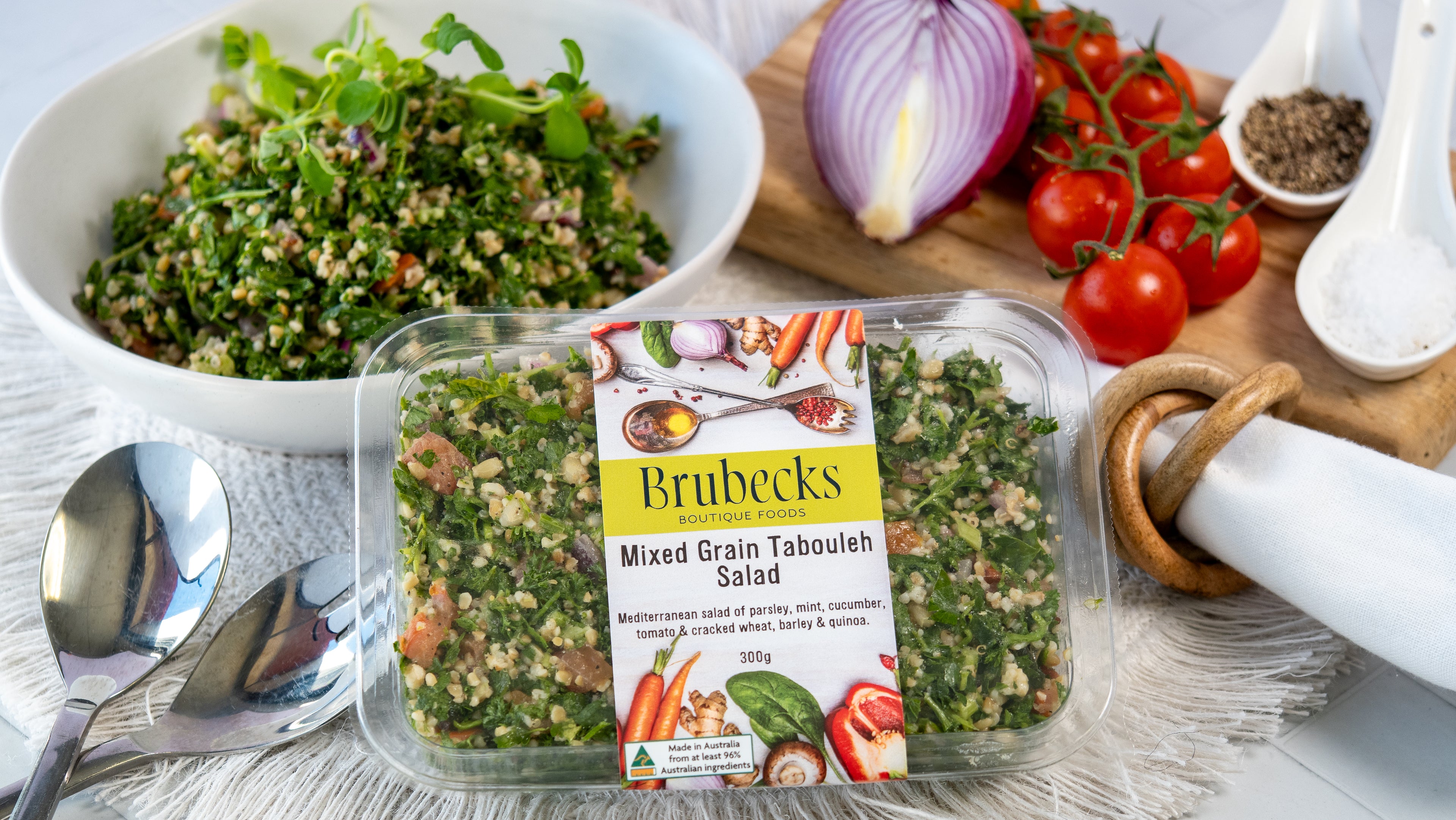 Brubecks Mixed Grain Tabouleh Salad packaging with a salad and ingredients on a table.